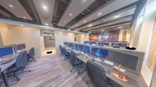 Finished training room with bench desking, oak partitions and exposed ceiling services